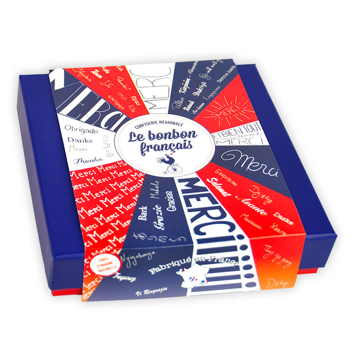 Coffret prestige Merci fermé, fourreau illustré d'une roue tricolore avec Merci en typographies variées