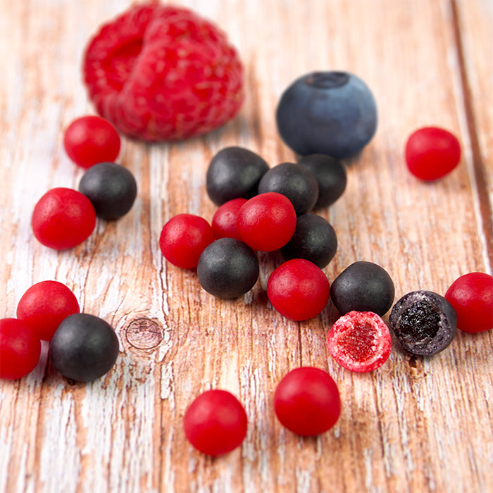 Framboises et Myrtilles d'Auvergne sur table en bois avec framboise et myrtille fraîches